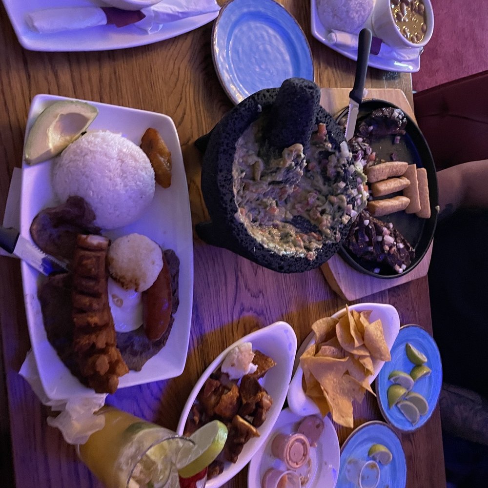 Noches De Colombia - a table full of food - Colombian Near Me - Mineola, New York Noches De Colombia - a table full of food - Colombian Near Me - Mineola, New York