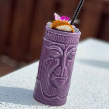 Hoosier Roots - a purple tiki with a straw and a flower - Food Trucks Near Me - Pittsboro, Indiana