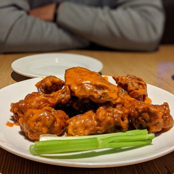 Applebee's Grill + Bar - a plate of chicken wings and celery - American Near Me - Palm Desert, California Applebee's Grill + Bar - a plate of chicken wings and celery - American Near Me - Palm Desert, California