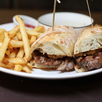 Traxx Restaurant - NY Steak Sandwich on toasted baguette w/horseradish aioli, crispy fried onions and au jus. - New American Near Me - Los Angeles, California Traxx Restaurant - NY Steak Sandwich on toasted baguette w/horseradish aioli, crispy fried onions and au jus. - New American Near Me - Los Angeles, California