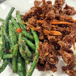 Garlic green beans, and crispy beef together on my plate, a match made in heaven