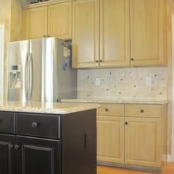 Craig W  Morgan Enterprises, Inc. - Builders white  Cabinets after Makeover. Matte Black island & wood grained cabinetry.