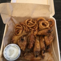 a tray of fried wings and onion rings a tray of fried wings and onion rings