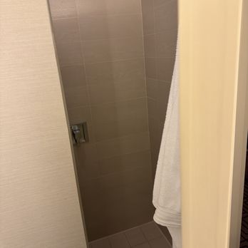 Renaissance Austin Hotel - Entrance to the tiny shower hidden behind the bathroom door. - Hotels Near Me - Austin, Texas