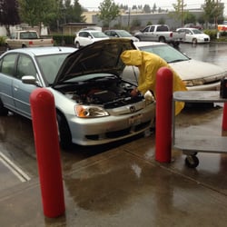 AutoZone - Store manager Gary helping me install my new battery....IN THE POURING RAIN!