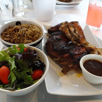 Yah Mon - Jerk Chicken comes with a side salad and a side of rice and peas. In the background is a delicious watermelon soda, also highly recommended - Caribbean Near Me - Tampa, Florida Yah Mon - Jerk Chicken comes with a side salad and a side of rice and peas. In the background is a delicious watermelon soda, also highly recommended - Caribbean Near Me - Tampa, Florida