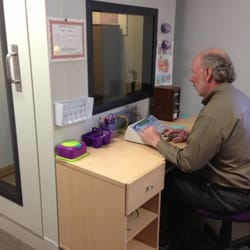 Higgins Hearing and Audiology - Tim Higgins performing a hearing test