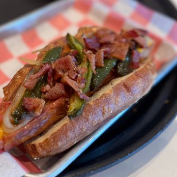 Max's Bar And Grill - The Cowboy Dog, grilled hotdog stuffed w/ American & Cheddar cheese, w/ grilled jalapeños, sautéed onions, bacon served on pretzel bun - Hot Dogs Near Me - Long Branch, New Jersey Max's Bar And Grill - The Cowboy Dog, grilled hotdog stuffed w/ American & Cheddar cheese, w/ grilled jalapeños, sautéed onions, bacon served on pretzel bun - Hot Dogs Near Me - Long Branch, New Jersey