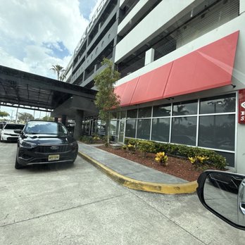 Rick Case Honda - Entrance to the collision center blocked by people just making their own parking spots. Not enough parking for customers. - Auto Repair Near Me - Davie, Florida