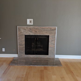 Decotal Construction & Remodeling - After photo of the fireplace; removed wood mantle, installed metal surround, new outlet, baseboards and paint. - General Contractors Near Me - Thousand Oaks, California