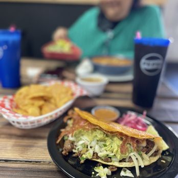 Taco Saas  - Close up shot of the Saas Attack with asada and a side of chips & salsa. Drinks are Jamaica & Horchata - Caterers Near Me