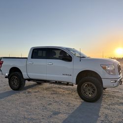 BlackJack Speed Shop - White Nissan Titan with 35 inch tires and 6-inch Rough Country lift.