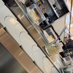 Conveyor belt with dessert and other edible items that can be purchased.