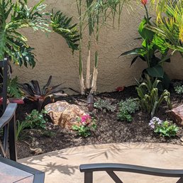 a patio with a table and chairs