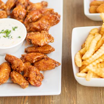 Perry Wings Express - a platter of chicken wings and french fries - Chicken Wings Near Me - Miami Gardens, Florida