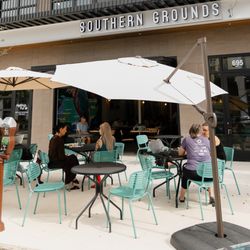 Southern Grounds - Outdoor seating at Southern Grounds on 695 Central Ave with guests enjoying coffee and brunch under umbrellas.