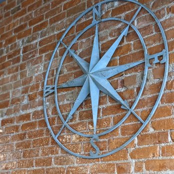 Tecumseh Brewing Company - a compass on a brick wall - Breweries Near Me - Tecumseh, Michigan