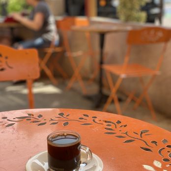 Uncle Momo - a cup of coffee on an orange table - Lebanese Near Me - Jersey City, New Jersey Uncle Momo - a cup of coffee on an orange table - Lebanese Near Me - Jersey City, New Jersey