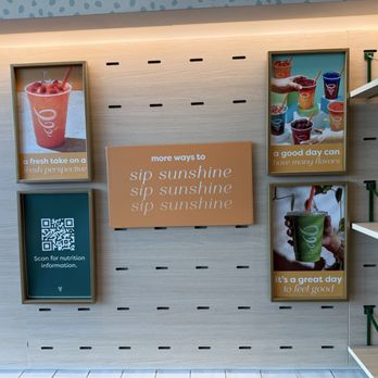 Jamba - Wall display featuring posters of smoothies and fruit drinks, a QR code for nutrition info, and motivational messages. - Juice Bars & Smoothies Near Me - Albuquerque, New Mexico