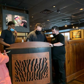 Outback Steakhouse - a man and woman ordering food - Steakhouses Near Me - Coon Rapids, Minnesota