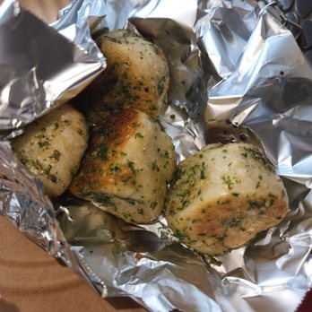 Angelica Pizza - a pile of baked potatoes wrapped in foil - Pizza Near Me - Brooklyn, New York