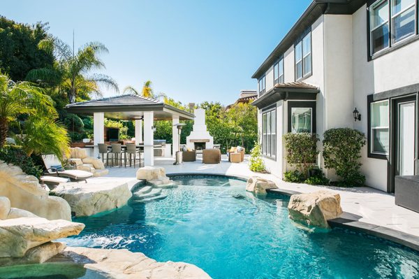 Complete Backyard Remodeling and Renovation - Modern Outdoor Kitchen, Swimming Pool, Spa and Fireplace - Complete backyard makeover. From start to finish Cat in a Hammock designed and built this gorgeous backyard with an outdoor kitchen under a beautiful cabana — with a fireplace, spa and pool with a water slide, gorgeous paver stone deck, and a cozy outdoor living room. Complete Backyard Remodeling and Renovation - Modern Outdoor Kitchen, Swimming Pool, Spa and Fireplace - Complete backyard makeover. From start to finish Cat in a Hammock designed and built this gorgeous backyard with an outdoor kitchen under a beautiful cabana — with a fireplace, spa and pool with a water slide, gorgeous paver stone deck, and a cozy outdoor living room.