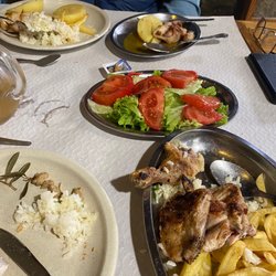Churrasqueira Tipica - Foreground: chicken, salad in middle of table, squid in background.