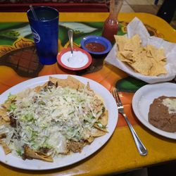 Casa Fiesta - Nachos Supremos with beans and sour cream on side. I ran out of chips so I used the chips in the basket