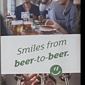 Bistro 103 - a man holding a beer and smiling - New American Near Me - Hialeah Gardens, Florida