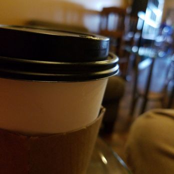 The Grind Cafe - a cup of coffee on a table - Coffee & Tea Near Me - Racine, Wisconsin