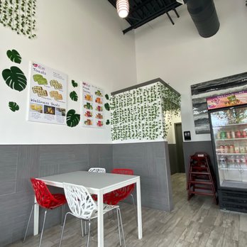 Cafe Acai - a white table and red chairs - Acai Bowls Near Me - Frisco, Texas Cafe Acai - a white table and red chairs - Acai Bowls Near Me - Frisco, Texas