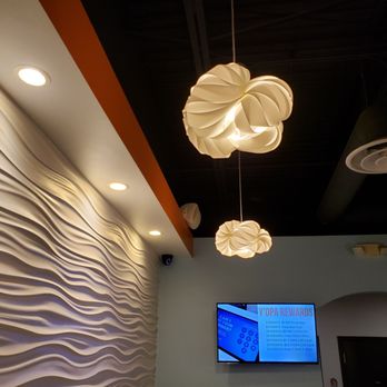 Y'OPA Frozen Yogurt - Textured wall with matching lighting. TV displaying weekly specials and loyalty points program details - Ice Cream & Frozen Yogurt Near Me - Portage, Michigan Y'OPA Frozen Yogurt - Textured wall with matching lighting. TV displaying weekly specials and loyalty points program details - Ice Cream & Frozen Yogurt Near Me - Portage, Michigan
