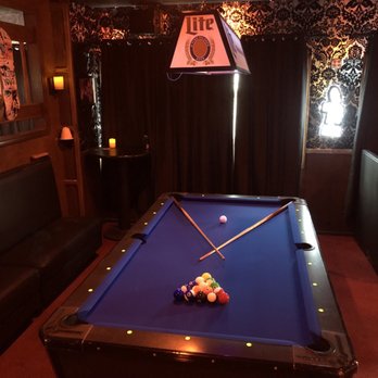 Graveyard Bar - a pool table with a billiards stick - Bars Near Me - Salem, Oregon