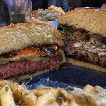 Eureka! - Half of the Bison burger medium rare and half of the Fresno fig medium. Great mix with the truffle fries. - Bars Near Me - Cerritos, California