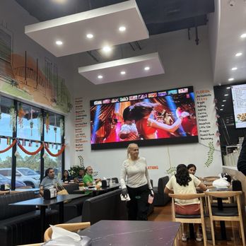 Desi Chowrastha - Front seating wth large screen Indian movie, most of them for decades are of love stories and dancing - Indian Near Me - Jacksonville, Florida