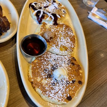 Snooze, an A.M. Eatery - Pancake trio with Blueberry Crunch, Pineapple Upside Down, and Chocolate Chip - Breakfast & Brunch Near Me - Addison, Texas