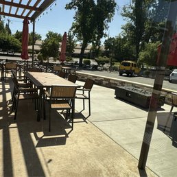 Slick patio with umbrellas and modern fire pit.  Great place to have cocktails with friends.