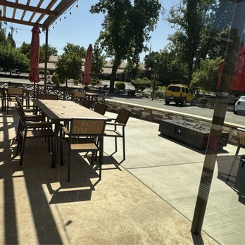 Woodside Grill - Slick patio with umbrellas and modern fire pit.  Great place to have cocktails with friends. - Bars Near Me - Anderson, California