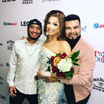 Kaliente - two men and a woman posing for a picture - Dance Clubs Near Me - Dallas, Texas