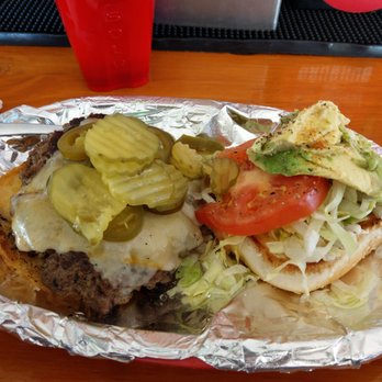Moe Dogs Grill - You can't see the hamburger under all the condiments but this was the special burger and the hamburger was very thick. - New American Near Me - Amarillo, Texas