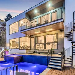 Vacation Inn - Elevated outdoor living with pool, spa, and sweeping views.