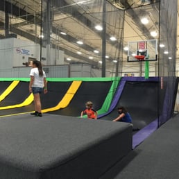 Curved trampoline and basketball hoop.