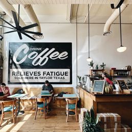 people sitting at tables in a coffee shop people sitting at tables in a coffee shop