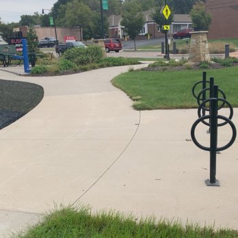 Oxbow Park - A view of some tables to the left and the entrance from the street as well as an area to secure bikes - Parks Near Me - Shawnee, Kansas Oxbow Park - A view of some tables to the left and the entrance from the street as well as an area to secure bikes - Parks Near Me - Shawnee, Kansas