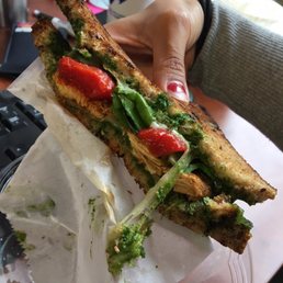 Tasty Chicken Pesto sandwich! With gruyere cheese, spinach, and roasted red peppers (ingredients and bread can vary. But still delish!)