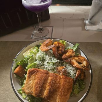 The Charlotte American Bistro - Caesar Salad with addition of Grilled Salmon and Cajun Shrimp - Bars Near Me - Dallas, Texas
