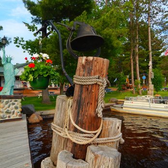 Rock Island - a wooden dock with a bell on it - Dive Bars Near Me - Merrill, Wisconsin