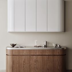 Seattle Cabinets - Soft white cabinetry paired with warm wood tones and subtle curves creates a calm, minimal kitchen feel.