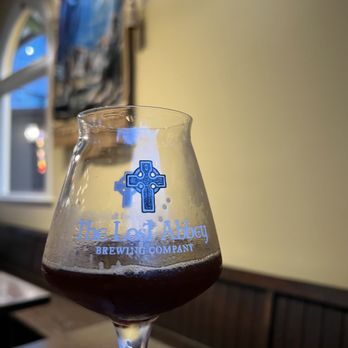 The Lost Abbey - a hand holding a glass of beer - Breweries Near Me - San Diego, California The Lost Abbey - a hand holding a glass of beer - Breweries Near Me - San Diego, California