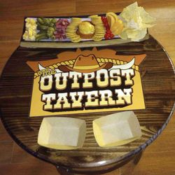 The Outpost Tavern - Charcuterie Board  Pineapple Rum Sauce w/cream Cheese & Crackers, Tostitos & Mexi-Cali Dip, Cheese, Beef Bites, Pickles, Olives, & Fruit.